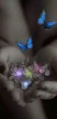 This stunning phone live wallpaper features a calming and dreamlike scene of butterflies held within someone's hands