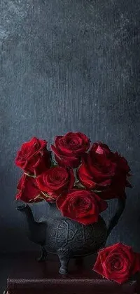 This dark-themed phone live wallpaper features a vase filled with beautiful red roses atop a book