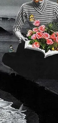 This phone live wallpaper showcases a captivating black and white photo of a person reading with flowers in their hair, set against the backdrop of the ocean