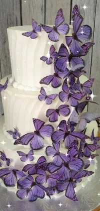 This stunning phone live wallpaper showcases a white cake with exquisite purple butterflies resting on top