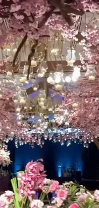This stunning phone live wallpaper features a beautiful room filled with pink flowers, draped in exquisite tiffany chandeliers