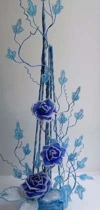 This enchanting phone live wallpaper showcases a tastefully decorated vase filled with serene blue flowers prominently positioned on top of a table