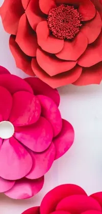 This beautiful live wallpaper for your phone features a stunning group of paper flowers arranged on a table