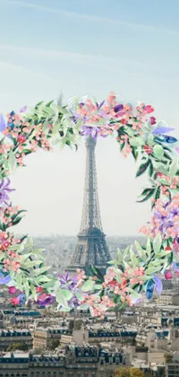 This phone live wallpaper showcases a wreath of colorful flowers set against the striking Eiffel Tower, creating an idyllic and dreamy scene