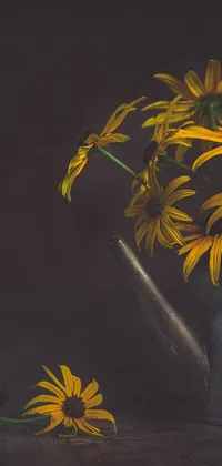 This metal watering can and yellow flower live wallpaper is a stunning still life shot that's sure to spruce up your phone background