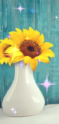 This phone live wallpaper features a white vase with a bright yellow sunflower set against a warm wooden background and cyan photographic backdrop