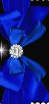 This phone live wallpaper displays a mesmerizing blue bow with diamonds set against a sleek black background