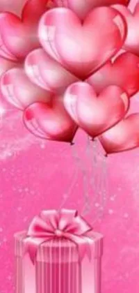 This live wallpaper features a charming and romantic design with balloons and a gift on a pink background