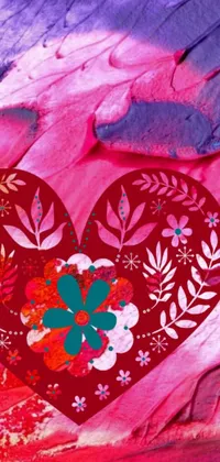 Looking for a vibrant and stunning live wallpaper for your phone's home screen? Look no further than this beautiful close-up of a heart adorned with flowers, set against a colorful and batik-like background