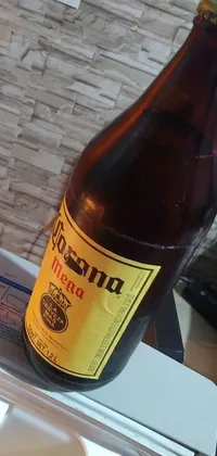 This phone live wallpaper features a realistic bottle of beer resting atop a refrigerator, creating a cozy and casual atmosphere