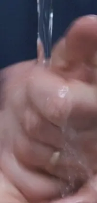 Experience a unique live wallpaper featuring a hand washing scene with water flowing from a faucet
