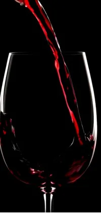 Enhance your smartphone with this live wallpaper showcasing the pouring of deep red wine into a stemmed glass