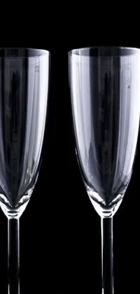 This live wallpaper features two empty wine glasses placed side by side against a black background
