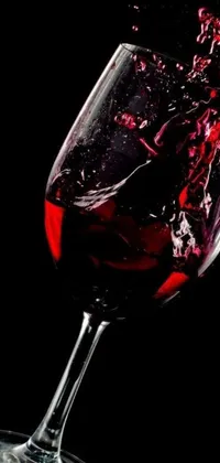 The phone live wallpaper showcases a classy glass filled with red wine being poured into it