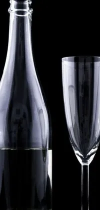 This live phone wallpaper features a beautiful still life of a wine bottle and glass on a table with a black background