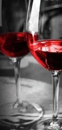 This live wallpaper features an elegant black and white photograph of two glasses of red wine on a table