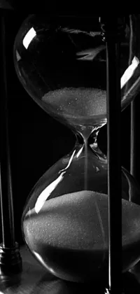 This live phone wallpaper features a stunning black and white hourglass photo that exudes a vintage vibe