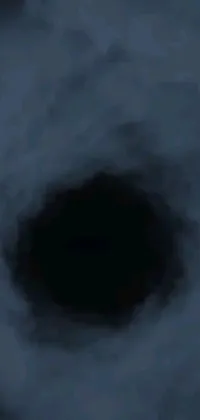This stunning live phone wallpaper showcases a digital painting of a black hole in the sky, surrounded by a dark blue mist in a polycount design