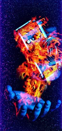 This phone live wallpaper captures an attention-grabbing image of a tight grip on a phone, immersed entirely in blazing, colorful fire
