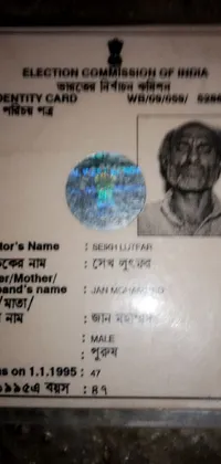 This phone live wallpaper offers a close-up view of an identification card on a table