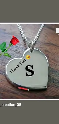 Decorate your home screen with a heart-shaped necklace live wallpaper featuring the letter "S" and shimmering gemstones