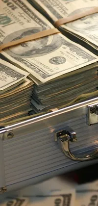 This is a stunning live wallpaper featuring a large suitcase full of money atop a wooden table