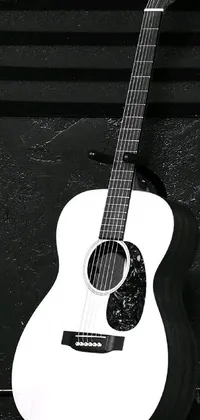 This sleek phone live wallpaper showcases a stunning black and white image of a beautifully crafted guitar