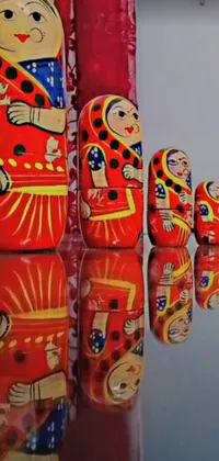 This mesmerizing phone live wallpaper boasts a group of matryoshka dolls arranged on a beautiful table