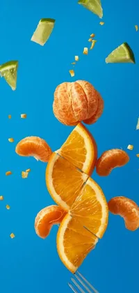 This phone live wallpaper features an orange being tossed in the air by a fork against a blue background with orange details