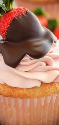 Gaze at this incredible live phone wallpaper featuring a chocolate covered cupcake topped with a tantalizing strawberry