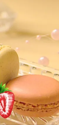 This live phone wallpaper features a stunning dessert design with two macarons resting on a glass plate