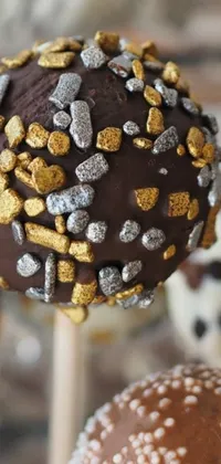 Indulge in a close-up of a chocolate cake on a stick with this phone live wallpaper