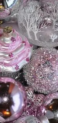 Bring some joy to your phone with this live wallpaper featuring a heap of pink and silver Christmas ornaments