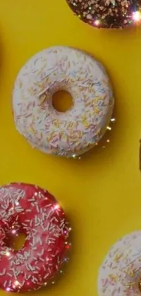 This live wallpaper is perfect for food lovers, featuring a colorful display of donuts with sprinkle toppings on yellow background, adding a touch of shine and sparkle, with a playful round-shaped profile picture effect