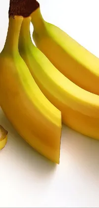 This live wallpaper features a bunch of bananas on a white table background