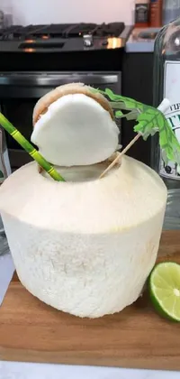 Looking for a tropical-themed live wallpaper for your phone? This dynamic design features a beautifully decorated coconut sitting on a wooden cutting board next to a bottle of alcohol