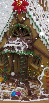 This live wallpaper features a close-up view of a gingerbread house on a plate, with intricate details highlighted in high definition
