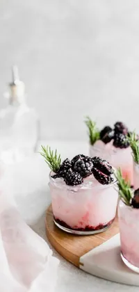 This live phone wallpaper showcases three mouth-watering desserts adorned with fresh blackberries and rosemary