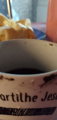 This live wallpaper features an up-close image of a coffee cup resting on a table
