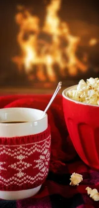 Get a cozy and stylish live phone wallpaper! Enjoy a delicious set up with a popcorn bowl and coffee cup on a wooden table