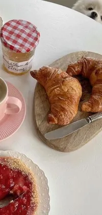 This stunning live wallpaper showcases a beautifully arranged table with croissants and pastries