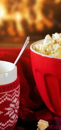 This delightful live wallpaper showcases a cozy bowl filled with warm popcorn and a steaming cup of coffee against a red velvet curtain