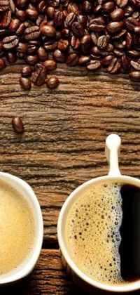 This phone live wallpaper showcases two cups of coffee beside a pile of coffee beans against a wooden backdrop