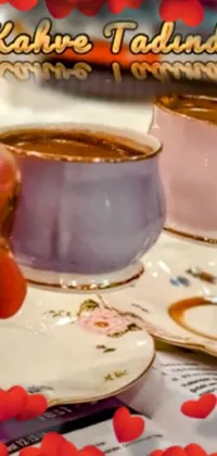 The coffee-inspired live wallpaper displays a colorful photograph of two cups of coffee on a wooden table, used as a phone background