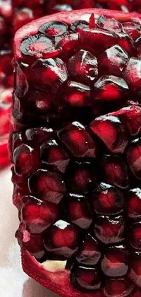This phone live wallpaper features a visually stunning close-up of a pomegranate on a plate with insects crawling on it, surrounded by precious gemstones that sparkle and shine