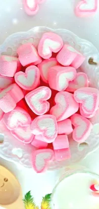 This charming phone live wallpaper depicts a delightful scene of a bowl of fluffy marshmallows and a glass of chilled milk, surrounded by playful pink hearts