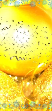 This lively phone live wallpaper features a yellow Christmas ornament resting on a table