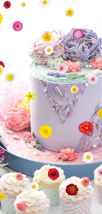 This stunning phone live wallpaper features a lavish cake and dainty cupcakes perched on a table