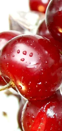 This live wallpaper captures a detailed, close-up view of delicious cherries, with a burst of deep red color that catches the eye