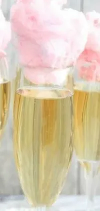 Decorate your phone screen with this champagne live wallpaper featuring three glasses filled with cotton candy floss